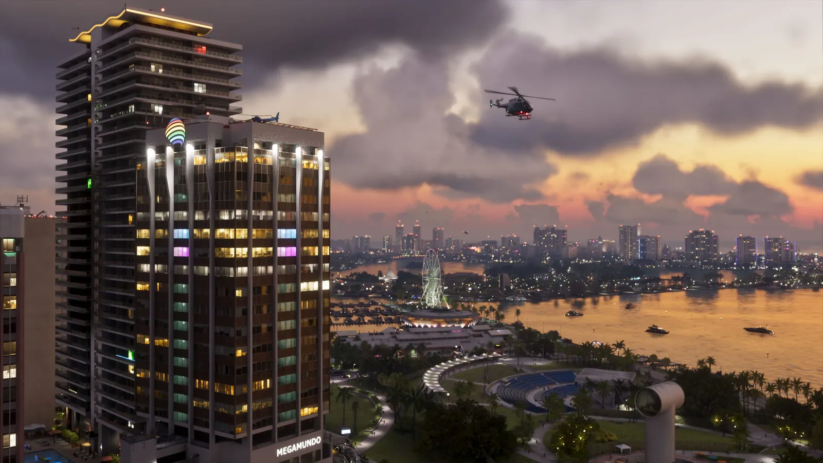 Vista aérea de Vice City al atardecer en GTA 6: rascacielos iluminados en primer plano, un helicóptero sobrevolando la ciudad, una noria junto al agua y el perfil urbano al fondo